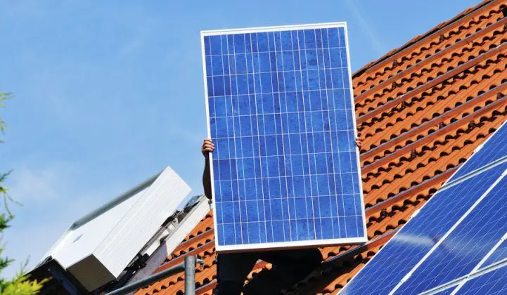 Installer holding a solar panel