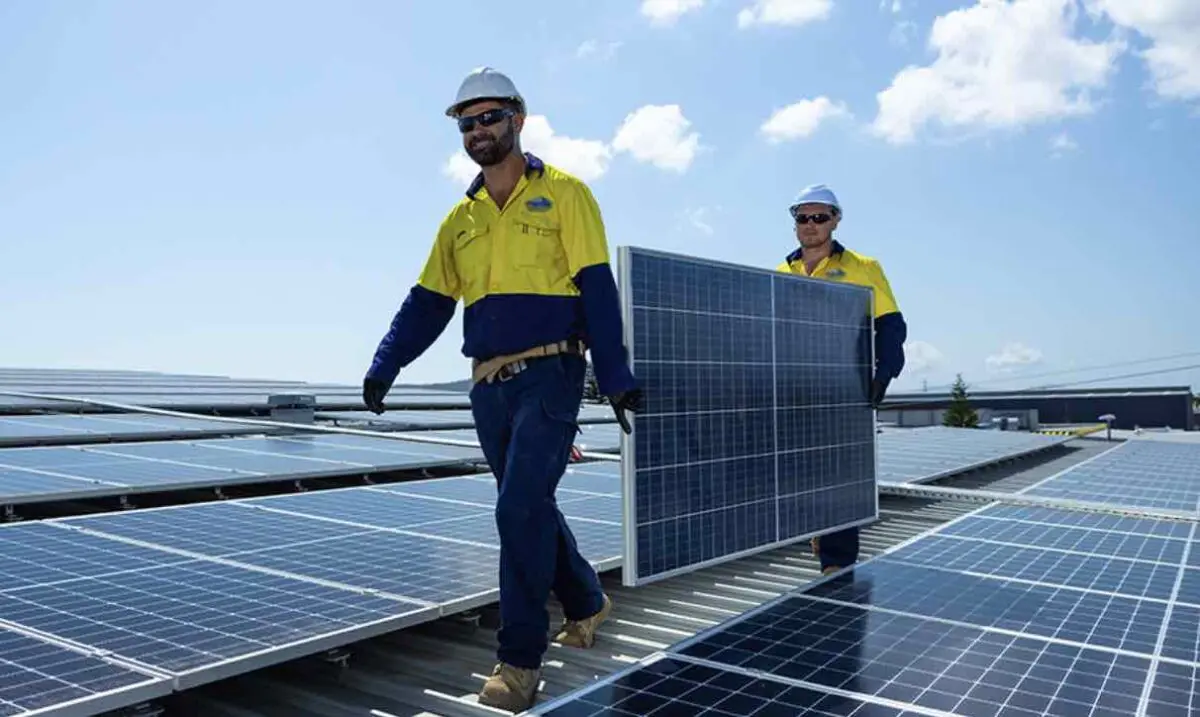 Solar Installers carrying a solar panel